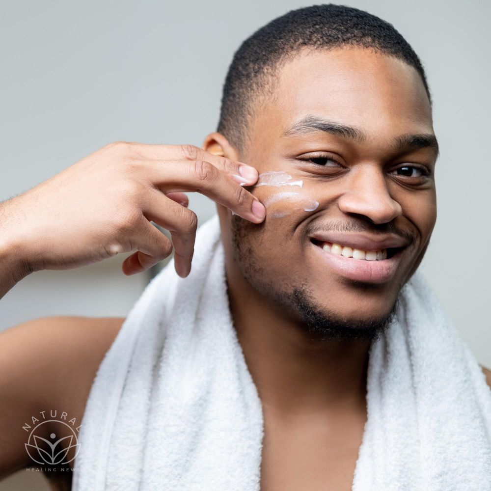 Man facial care cosmetic product metrosexual lifestyle cheerful shirtless african guy with white tow
